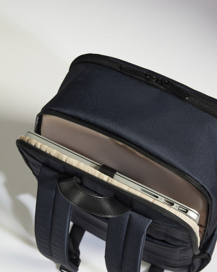 a black backpack with a laptop inside