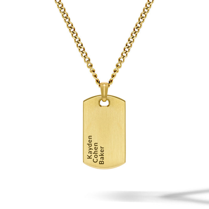 Gold necklace with a dog tag pendant on a white background