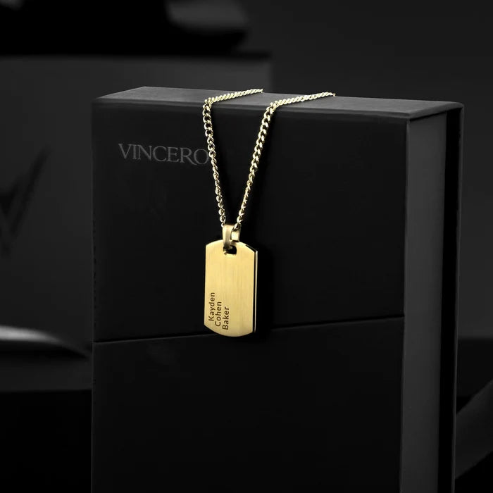 Gold necklace with a tag on a black box branded 'Vincero'.