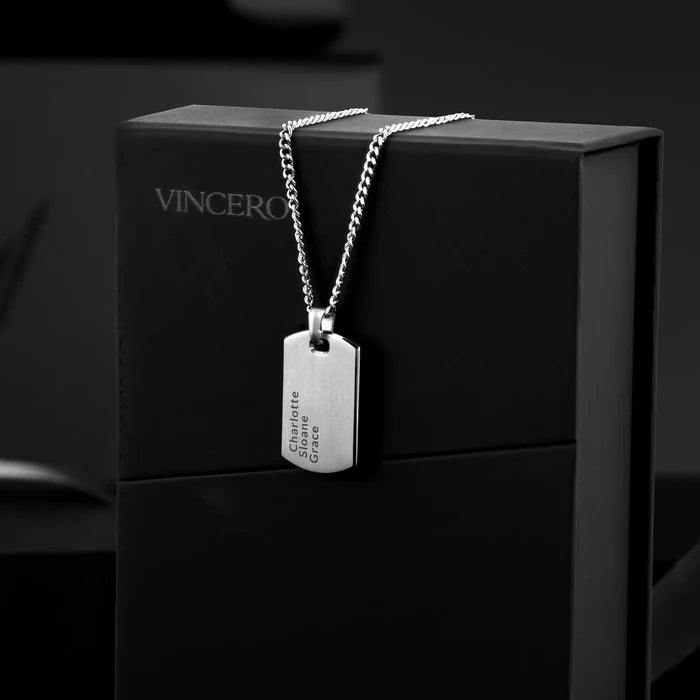 Silver necklace with a tag on a black box branded 'Vincero'.