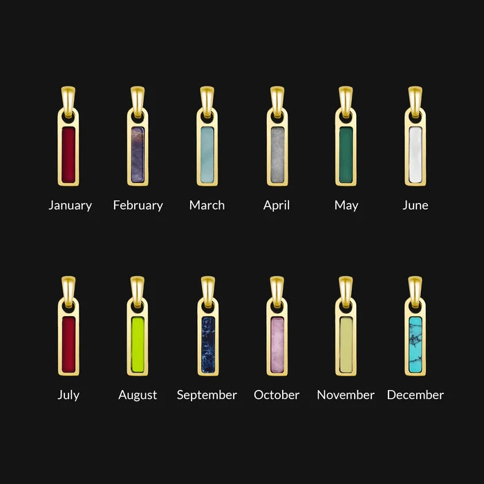 Set of gold necklaces with colored stones for each month on a black background