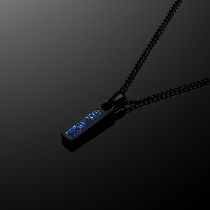 Black necklace with a blue pendant on a dark background