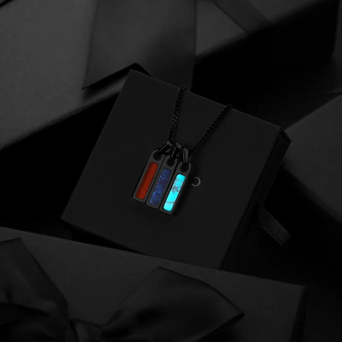 Necklace with colorful pendant on a black box