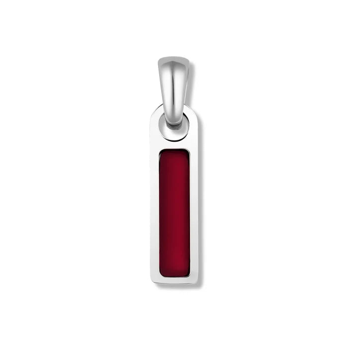 A silver pendant with a red tag attached to it.