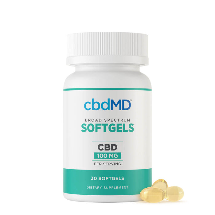 A white bottle of cbdMD Softgels 100 mg CBD dietary supplement, shown with three translucent softgel capsules resting on the surface next to it against a clean white background.; Strength: 3000MG;