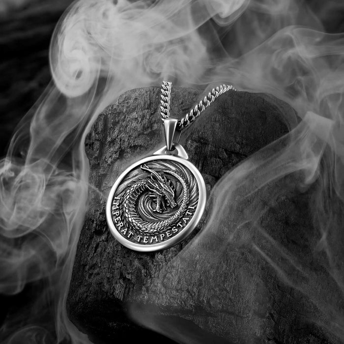 Silver pendant with dragon design on a stone with smoke