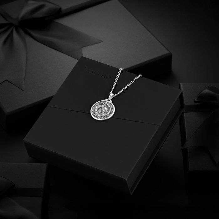 Silver necklace with a pendant on a black box