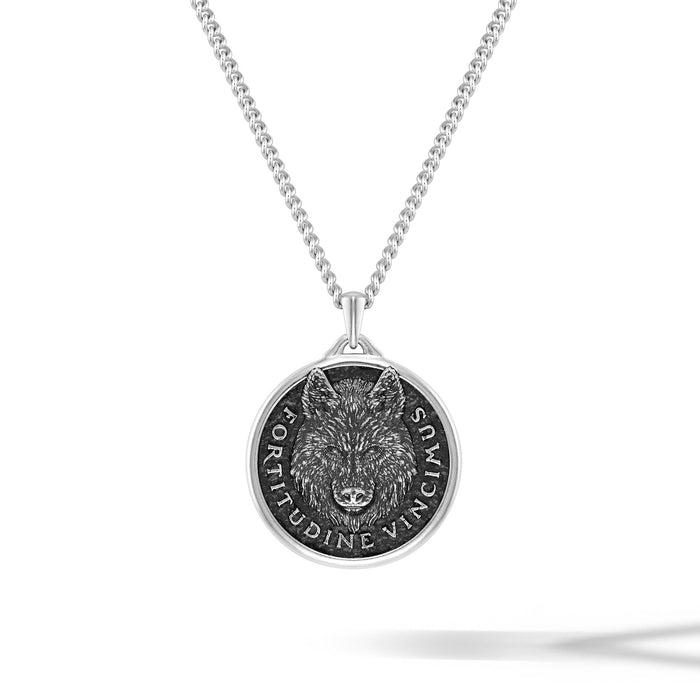 Silver necklace with a wolf pendant on a white background