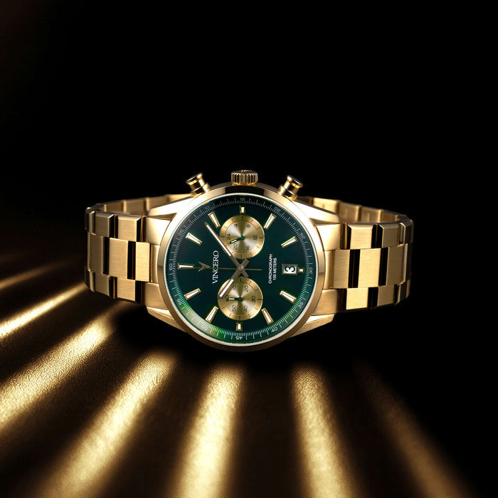 Gold wristwatch with a green face on a dark background