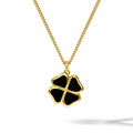 Gold necklace with a black four-leaf clover pendant on a white background