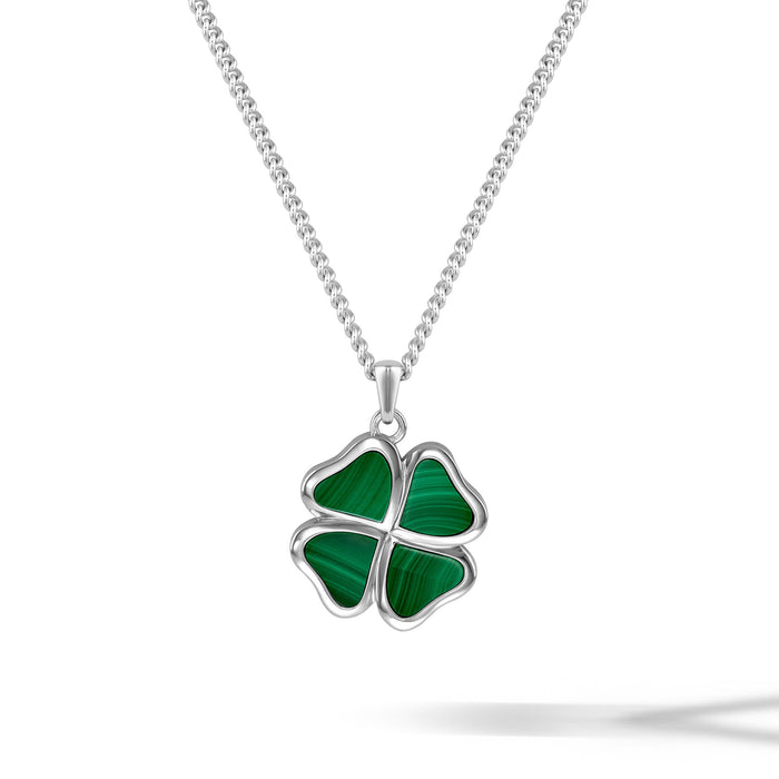 Four-leaf clover pendant on a silver chain against a white background