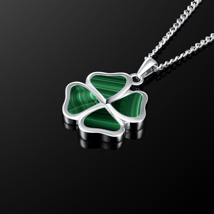 Four-leaf clover pendant necklace on a black background