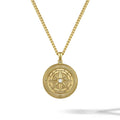 Gold necklace with a circular pendant on a white background