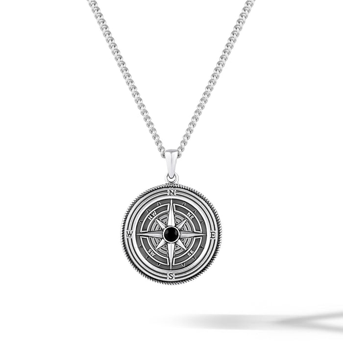 Silver compass pendant necklace on a white background