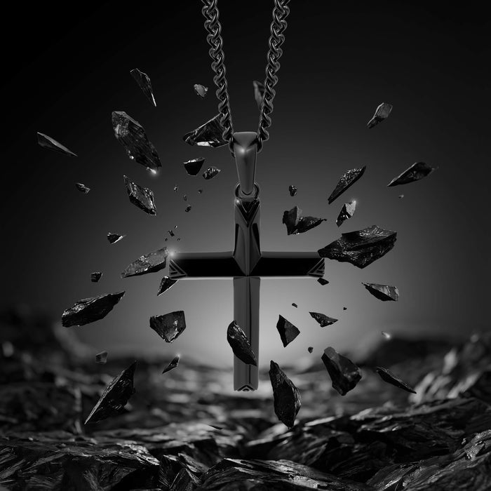 Black cross pendant with shattered glass effect on a dark background