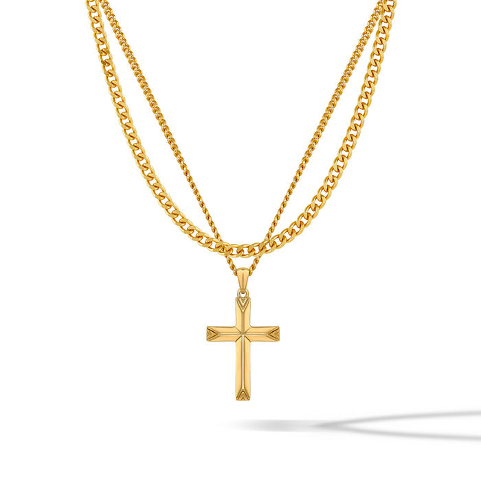A gold-colored cross pendant hanging on a gold-colored chain against a white background.