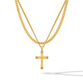 A gold-colored cross pendant hanging on a gold-colored chain against a white background.
