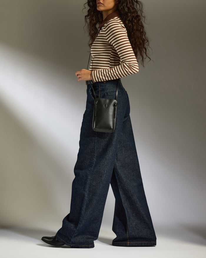 a woman walking with a bag