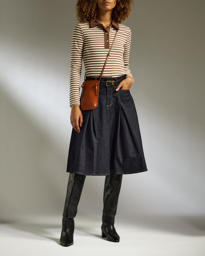 a woman in a skirt and boots