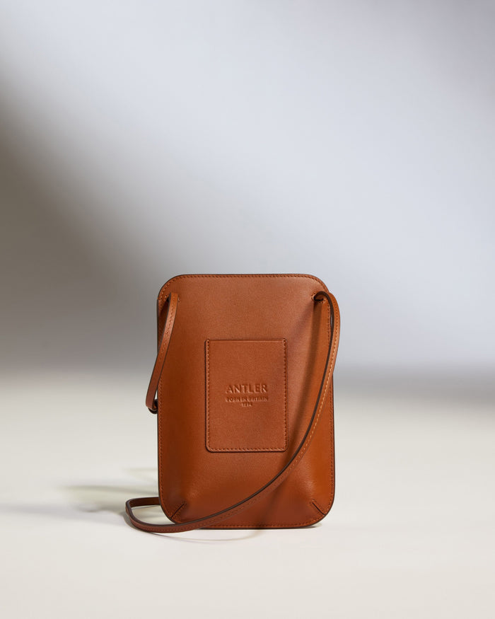 a brown leather bag with a strap