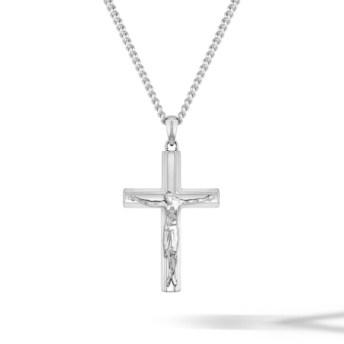Silver crucifix pendant on a chain against a white background