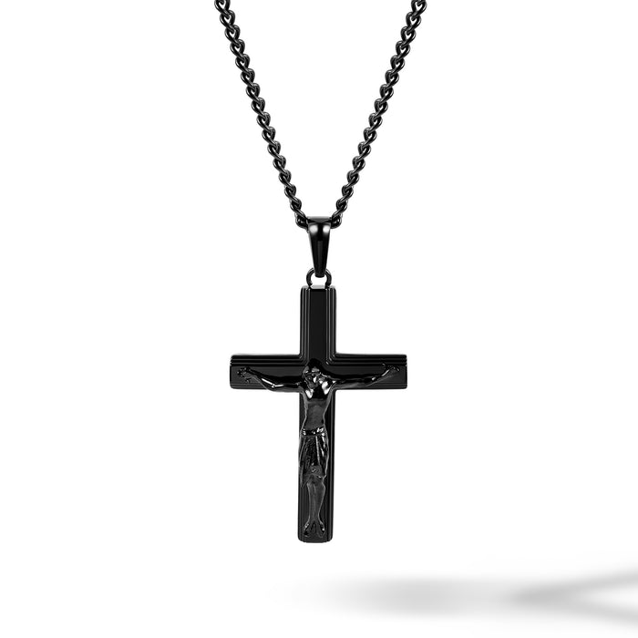 Black crucifix pendant on a chain against a white background