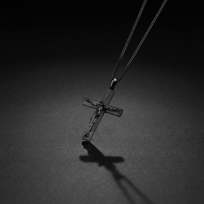Black crucifix pendant for men on black background.