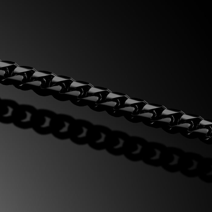 Close-up of a black chain on a dark background