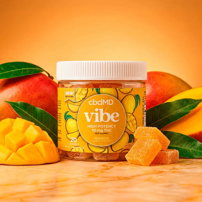 Mango THC gummies jar labeled 'Vibe' with fresh mango pieces and leaves on an orange background.; Flavor: Mango;