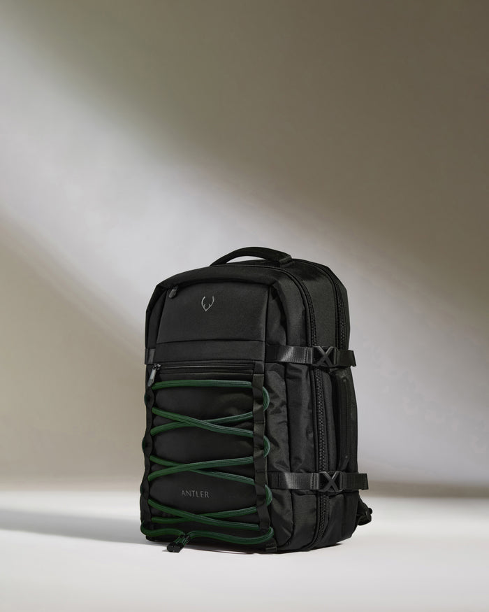 a black backpack with green straps