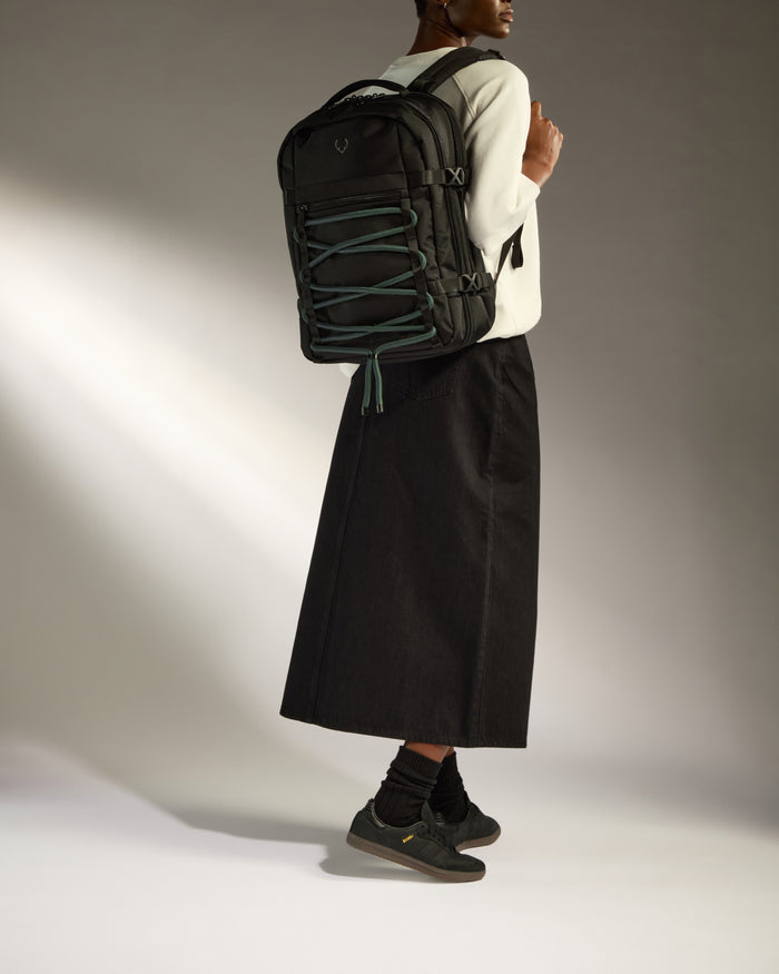 a person wearing a long skirt and a backpack