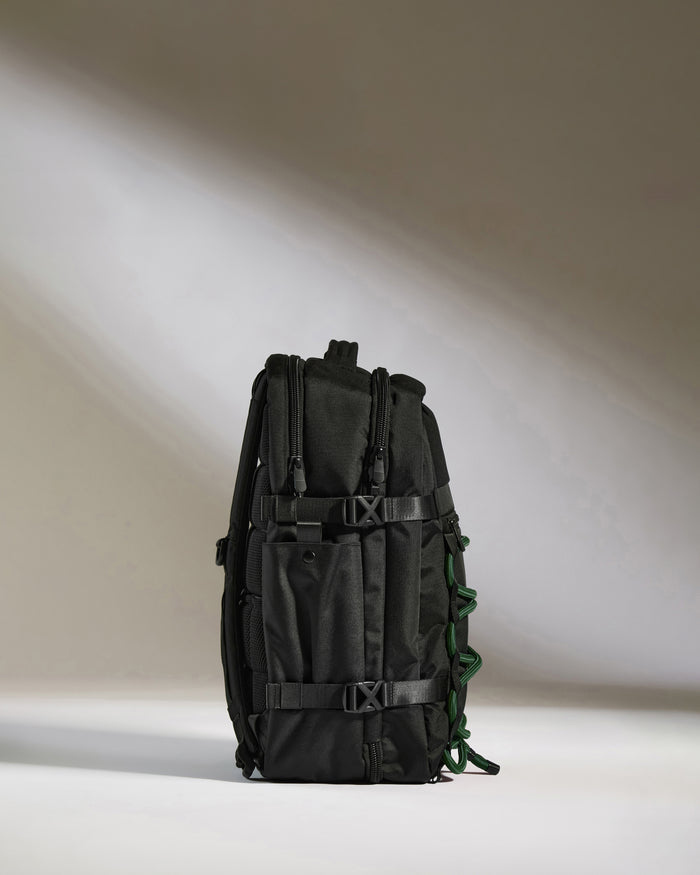 a black backpack with green straps