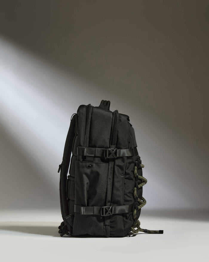 a black backpack with a light shining on it