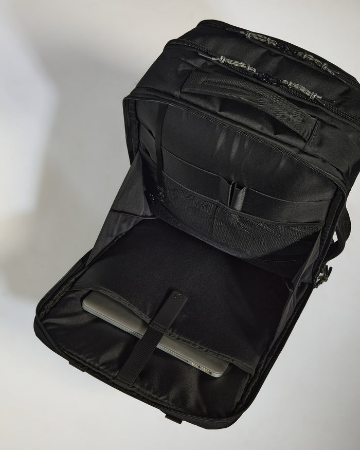 a black bag with a silver object inside