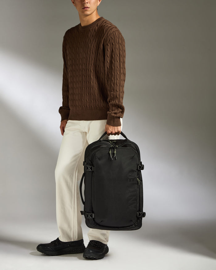 a man holding a black bag