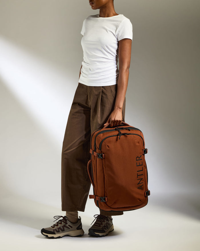 a woman holding a luggage bag