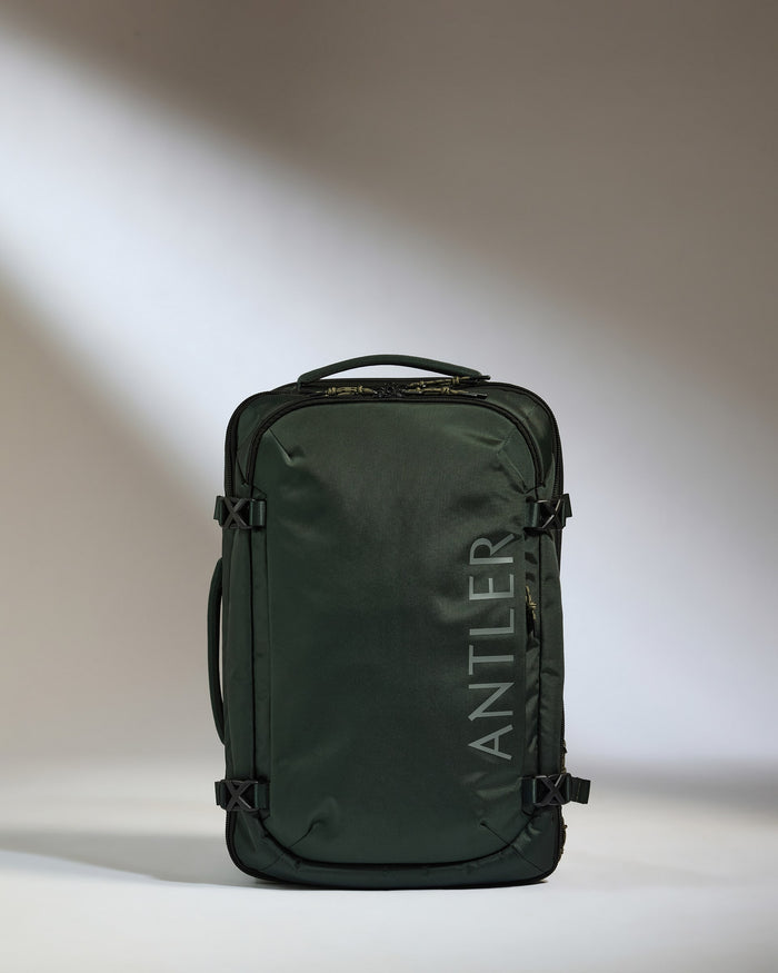 a green suitcase with a handle
