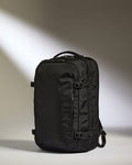 a black backpack with a light shining on it