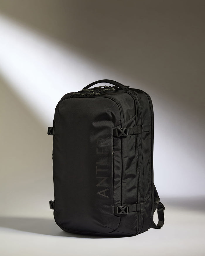 a black backpack with a light shining on it