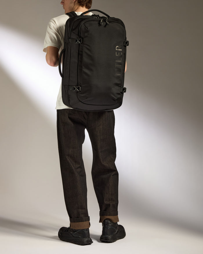 a man carrying a black bag