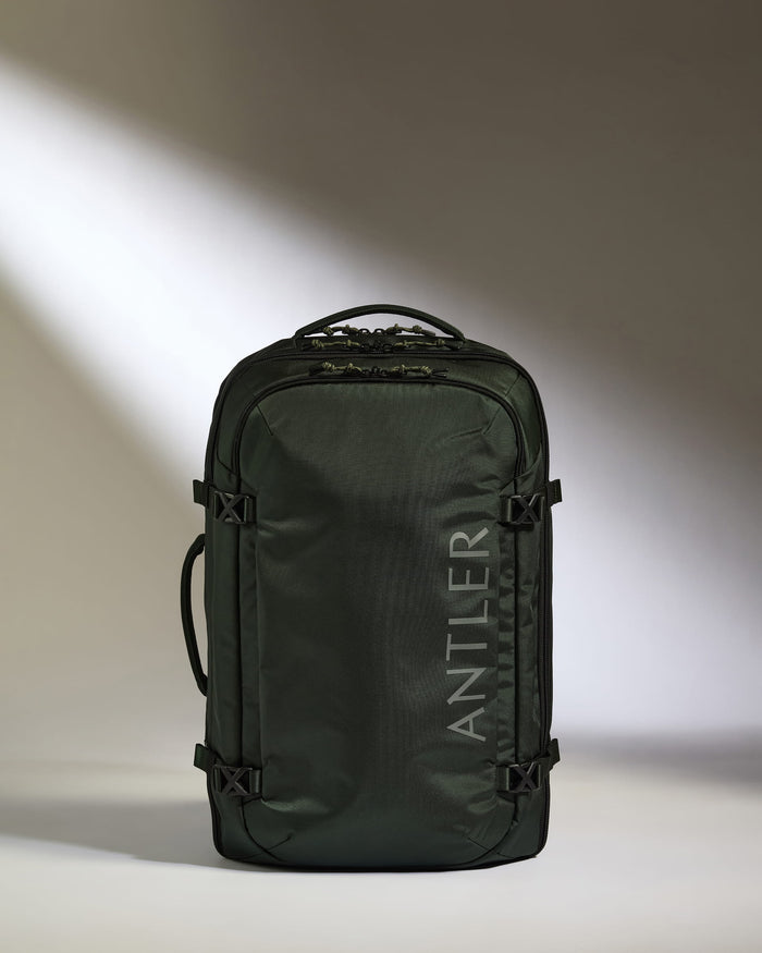 a green backpack with a white text on it