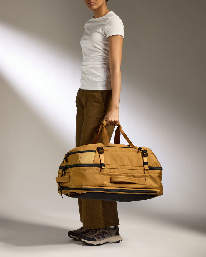 a woman holding a large bag