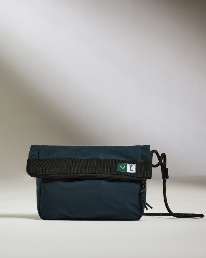 a blue bag with a black strap