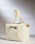 a white bag with a green strap