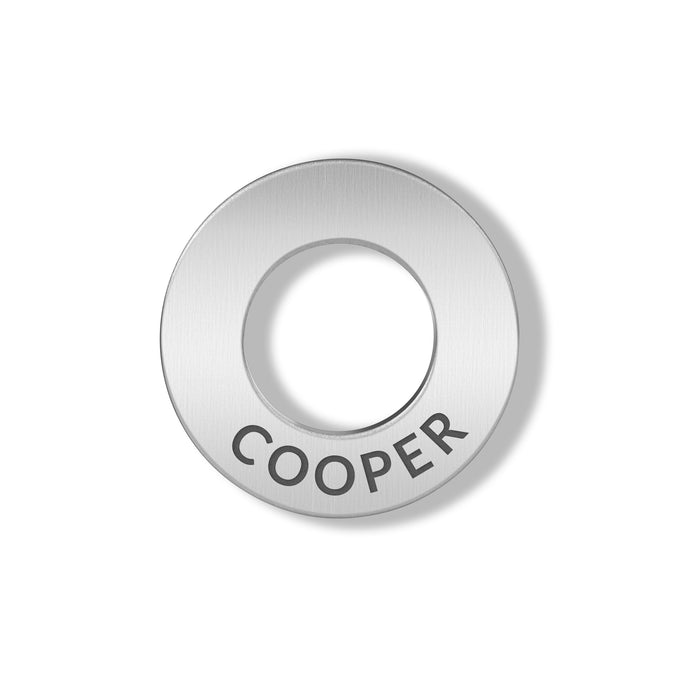 Silver round charm with 'COOPER' engraved on a white background