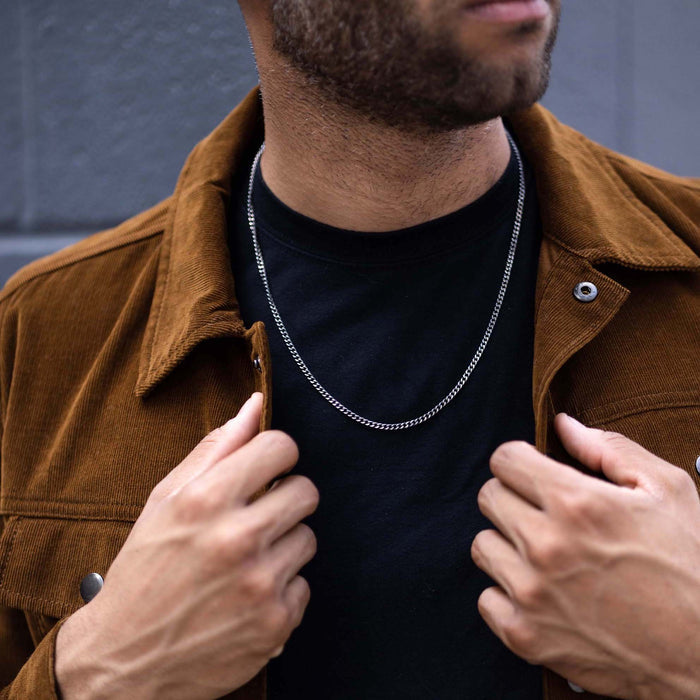 Silver curb chain on neck
