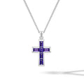 Silver cross pendant with purple stones on a chain against a purple background
