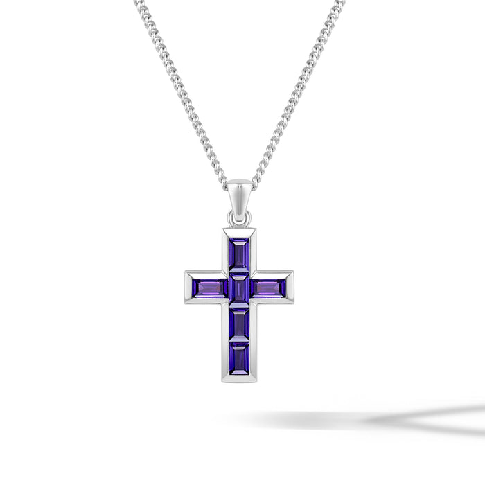 Silver cross pendant with purple stones on a chain against a purple background