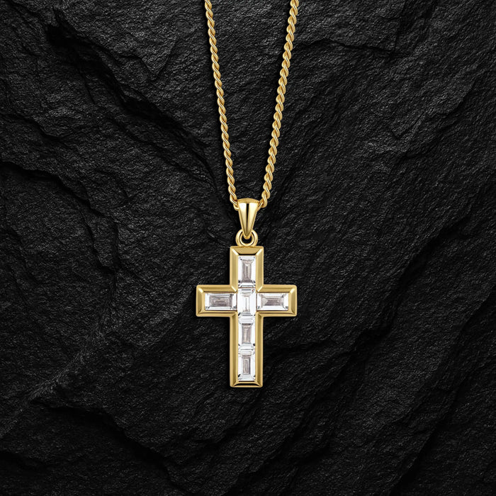 Gold cross pendant necklace on a black stone background
