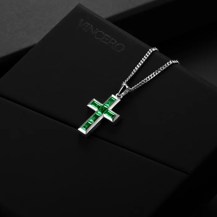 Silver cross pendant with red stones on a chain